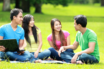 Group of young student using laptop outdoor