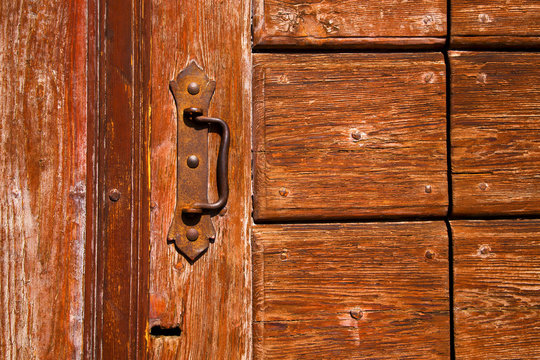 brass brown knocker and wood  door cairate varese italy