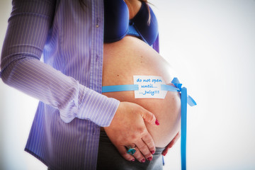 Pregnant belly isolated against white background