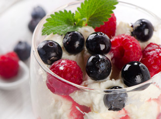 Dessert with berries and mint leaf. Selective focus