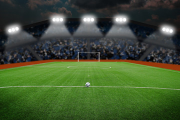 Fototapeta na wymiar Soccer ball on field in stadium at night