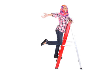 Young Asian Muslim school girl climbing a ladder with backpack © akulamatiau