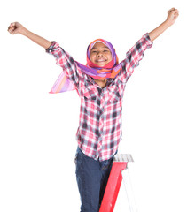 Young Asian Muslim school girl climbing a ladder with backpack