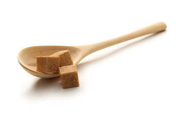 Cane sugar with wooden spoon