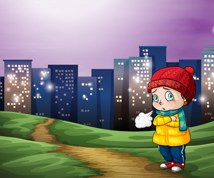 A young child across the tall buildings in the city