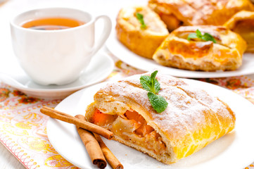 slice of an apple strudel with tea