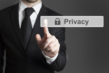 businessman in suite pressing touchscreen privacy