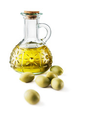 Glass bottle of premium virgin olive oil and some olives