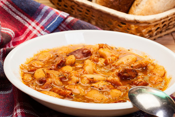 Beans with tomato sauce, bacon and sausage