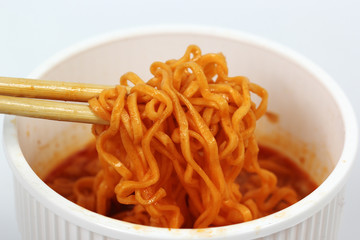 Instant noodles in the cup with chopsticks