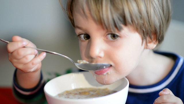 Boy Eating Cereal with Milk