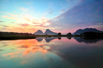 Naklejka na ściany i meble Beautiful reflection by the lakeside during sunrise