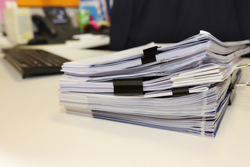 pile of documents on the office desk