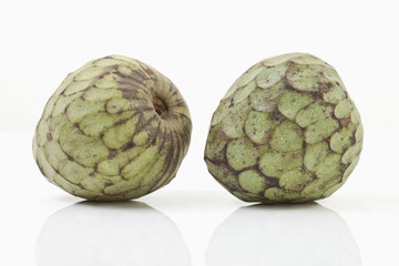 Zwei Cherimoya auf weißem Hintergrund