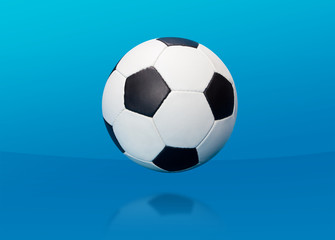 Fototapeta na wymiar Soccer ball over blue