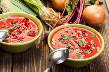 Beetroot soup with fresh vegetables in a bowl