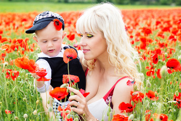Happy mother and son on the poppies field