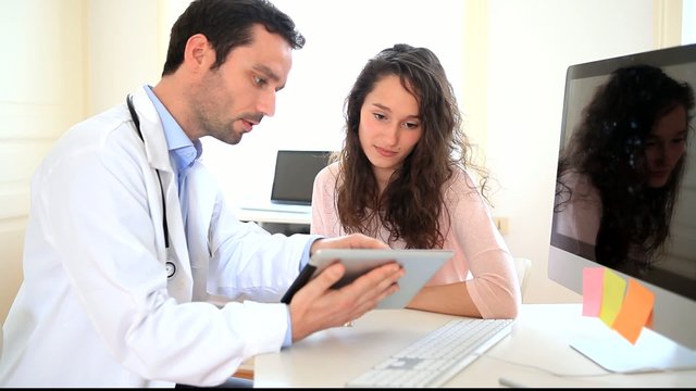 Doctor using tablet to inform patient 