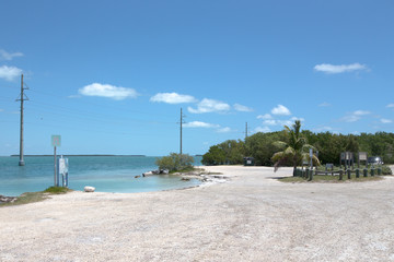 Shoreline of the Florida Keys with pretty blue sky and clouds.