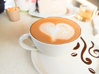 Cup of coffee with heart pattern in a white cup