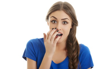 Surprised woman with hand over mouth