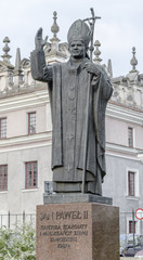 Jan Paul II monument in the courtyard of the cathedral - obrazy, fototapety, plakaty