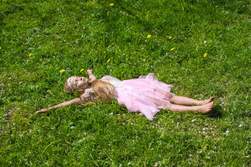 Adorable little girl have fun in blossoming apple orchard