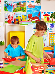 Children with teacher at classroom.