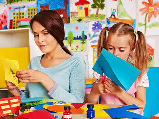 Children with teacher at classroom.