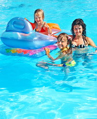 Family in swimming pool.