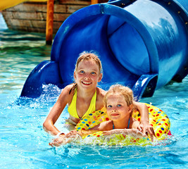 Child on water slide at aquapark.