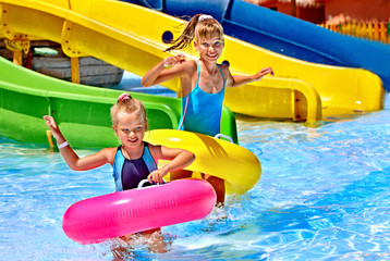 Child on water slide at aquapark.