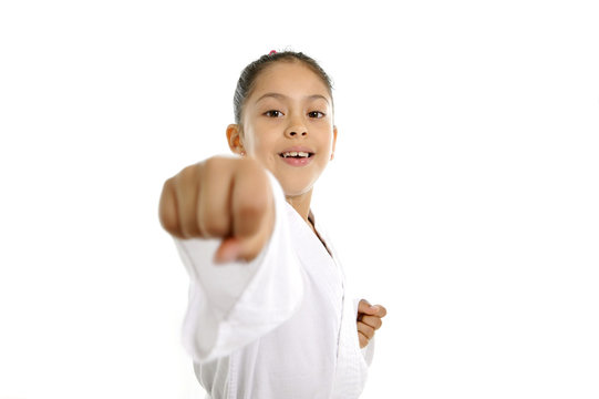 cute little girl in karate martial arts training punch attack