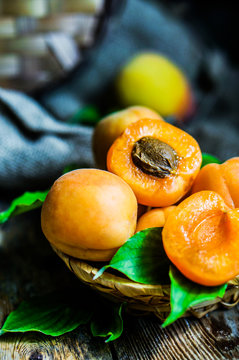 Apricots on rustic wooden background