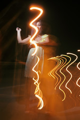 Cute lady having fun in summer night with  lightpainting