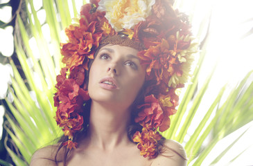 Pretty lady wearing hat made of flowers