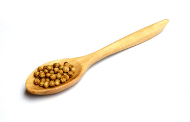 coriander seeds in wooden spoon