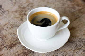 Cup of coffee on a wooden table