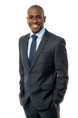 Confident businessman with hands in pockets