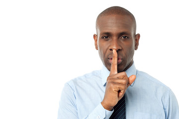 Businessman shows silence gesture