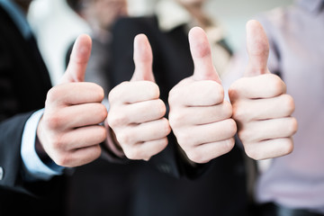 Group of hands with thumbs up expressing positivity