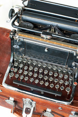 Old retro black metallic typewriter with antique round  keys.