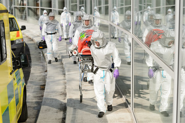 Biohazard medical team walking to building