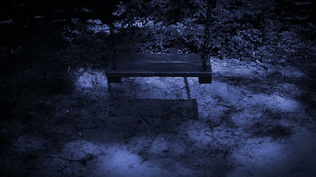 Old empty swing at night.
