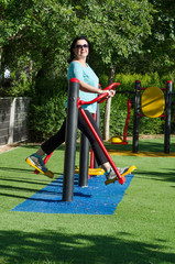 Woman working out on a air walker station outdoor