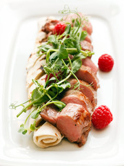 grilled duck breast covered with sweet red fruit sauce
