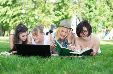 Group of young student using laptop together
