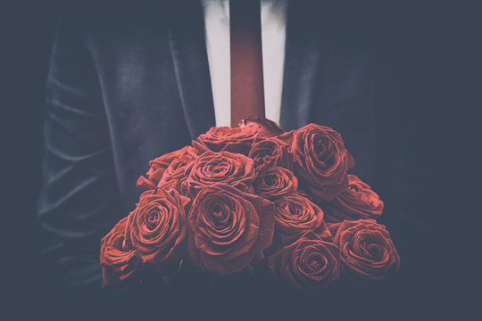 Man offers a bouquet of roses