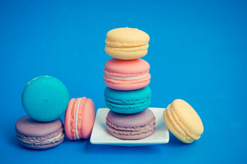 Sweet and colourful french macaroons on background