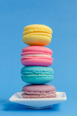Sweet and colourful french macaroons on background